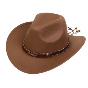 Detail of a brown cowboy hat featuring a braided decorative band and golden feather pendant