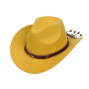 Detail of yellow felt cowboy hat featuring woven band with golden feather and tassels