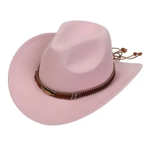 Detail of pink felt cowboy hat featuring brown band with metal feather and wooden beads