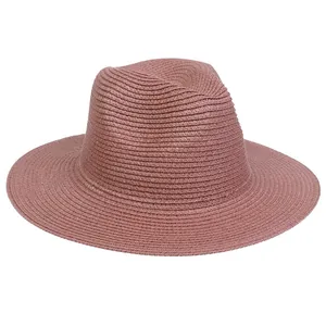 Detail of dusty rose straw sun hat with fedora crown and wide brim weave texture