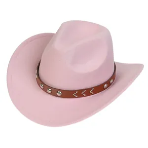 Detail of pink cowboy hat featuring brown leather band with silver metal arrow buckles