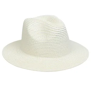 Detail of white woven straw fedora hat featuring a classic indented crown and fine texture