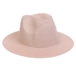 Detail of light pink woven straw fedora hat showing tight texture and matte finish