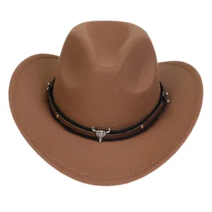 Detail of brown cowboy hat featuring silver bull skull ornament and metallic rivets