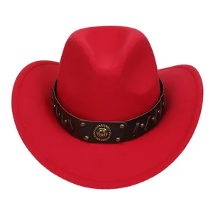 Close-up of red felt cowboy hat featuring black leather band and gold horseshoe emblem