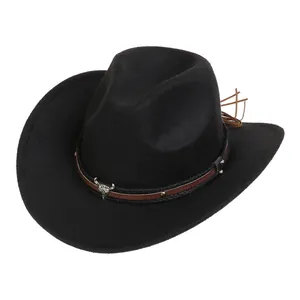 Detailed macro view of black wool cowboy hat featuring silver bull skull ornament