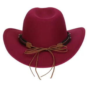 Detail of burgundy wool felt cowboy hat with stitched leather band and metal bead accents
