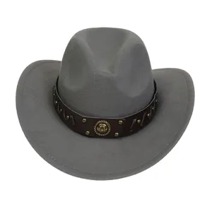 Detail of gray felt cowboy hat featuring leather band with gold studs and vintage emblem