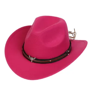 Detail of rose red felt cowboy hat featuring silver bull head ornament and metal studs
