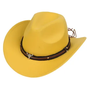 Detailed close-up of a mustard yellow felt cowboy hat with a decorative bull skull emblem