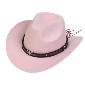 Detail of pink felt cowboy hat featuring brown leather band and silver bull skull charm