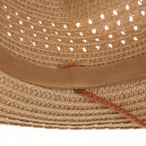 Close-up detail of the woven straw texture and inner fabric sweatband of the cowboy hat
