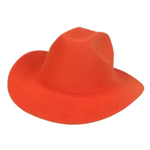 Detail of a bright orange wide-brimmed felt cowboy hat with a high-crown and matte texture
