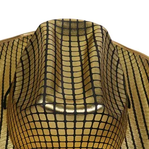 Detail of gold checkered sequin texture on western style party cowboy hat