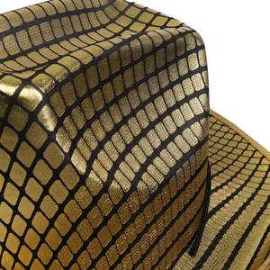 Macro shot of gold metallic foil western cowboy hat with black mesh texture and trim
