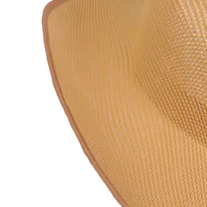 Detailed macro view of woven straw texture and fabric edging on the sun hat brim