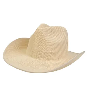 Detailed macro view of the woven texture and curved brim of the beige straw cowboy hat