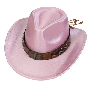 Detail of pink glitter cowboy hat with leather band and metal bull head emblem