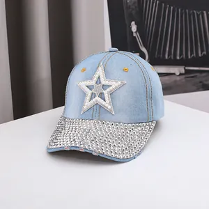 Close-up of light blue denim baseball cap featuring pearl and rhinestone star patch