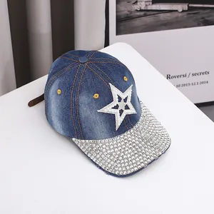Detailed view of blue denim baseball cap with rhinestone brim and white star patch