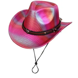 Close-up of holographic pink cowboy hat featuring a studded band and silver bull head charm