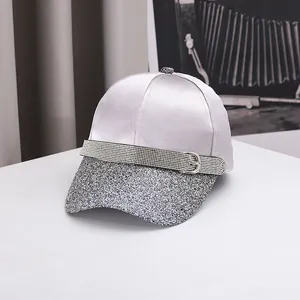 Close-up of lavender satin baseball cap featuring glitter brim and silver buckle detail