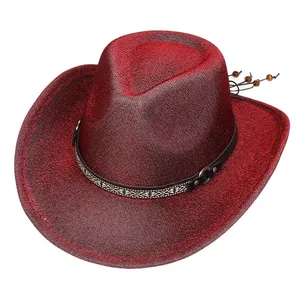 Macro detail of red glitter cowboy hat with ethnic style leather band and metal buckle