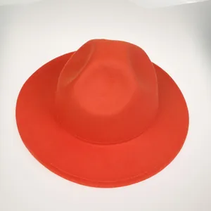 Top view of red felt fedora hat showing wide flat brim and teardrop crown detail