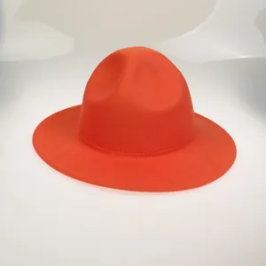 Detail shot of bright orange felt fedora featuring a wide flat brim and reinforced stitching