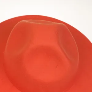 Detailed close-up of orange wool felt fedora showing high-quality stitching and texture
