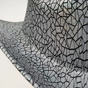 Detailed close-up of the silver and black textured brim of a party cowboy hat with glitter finish