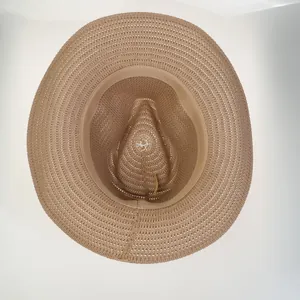 Detail view of khaki woven straw hat with breathable hollow pattern and inner sweatband