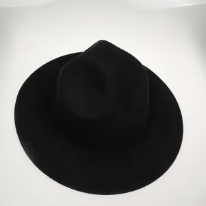 Top view of a black wool felt jazz hat with wide brim and classic crown indentation