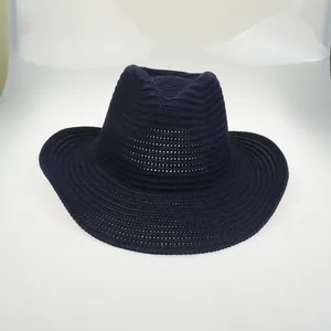 Detail of navy blue knitted fedora hat with spiral stitching and wide brim design