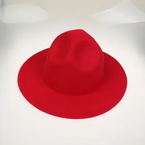 Top view of bright red felt fedora hat with classic indented crown and flat brim