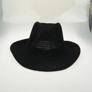 Detailed close-up of a black woven sun hat featuring concentric spiral texture and jazz crown