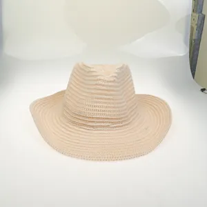 Close-up of beige woven wide brim sun hat with detailed straw texture and fedora top