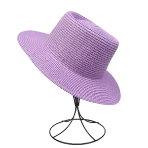 Detailed close-up of purple straw boater hat with fine woven texture on a white background
