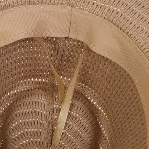 Detail of western straw hat interior showing the sweatband and adjustable satin drawstring