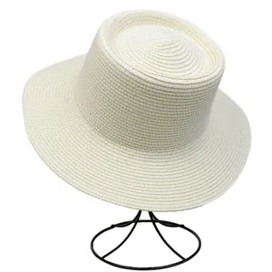 Detail view of woven boater hat featuring spiral straw texture and flat top design