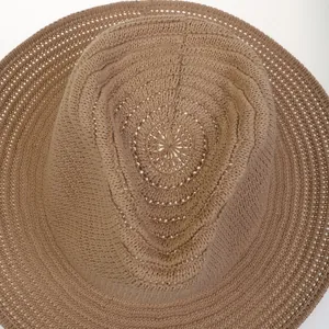 Macro view of the khaki woven sun hat showing intricate texture and crown structure