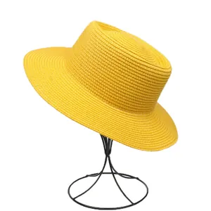 Detail of the fine woven texture and vibrant yellow color of the straw boater hat