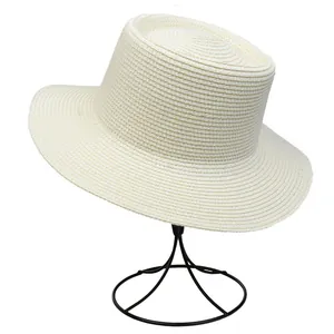 Detailed view of beige straw boater hat showing intricate woven texture and flat top design