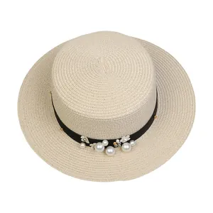 Detail showing the intricate straw weave and elegant pearl flower accents on the boater hat