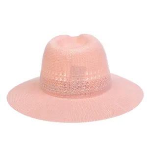 Close-up of pink woven sun hat featuring delicate hollow texture and classic crown