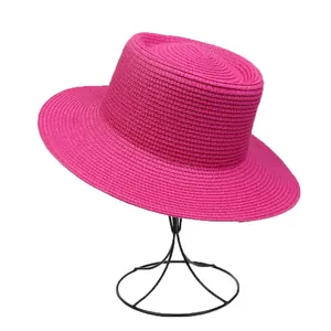 Close-up of bright pink woven straw hat texture with elegant flat top design