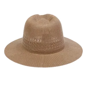Close-up of the woven texture and classic dented crown on a tan straw fedora sun hat