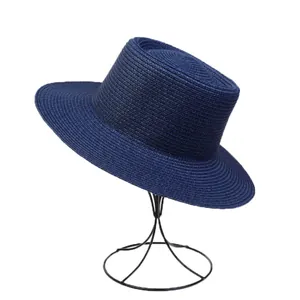 Detail of navy blue straw hat showing fine woven texture and flat top design