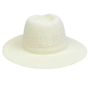 Close-up of cream hollow-out woven straw hat with breathable summer pattern details