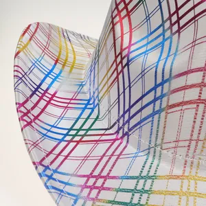 Macro view of colorful rainbow plaid pattern and stitching detail on the festive hat